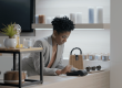 Femme professionnelle effectuant une transaction sur terminal moderne dans une boutique élégante et lumineuse.
